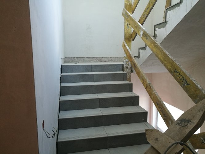 Budynek 6 - początek prac aranżacyjnych w częściach wspólnych. Układanie kafli na schodach w sekcji A.