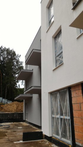 Budynek 1 - fragment elewacji południowej przed montażem balustrad, widoczna izolacja tarasów.
